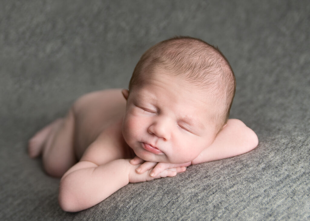 Beautiful baby boy on grey backdrop by wirral newborn baby photographer